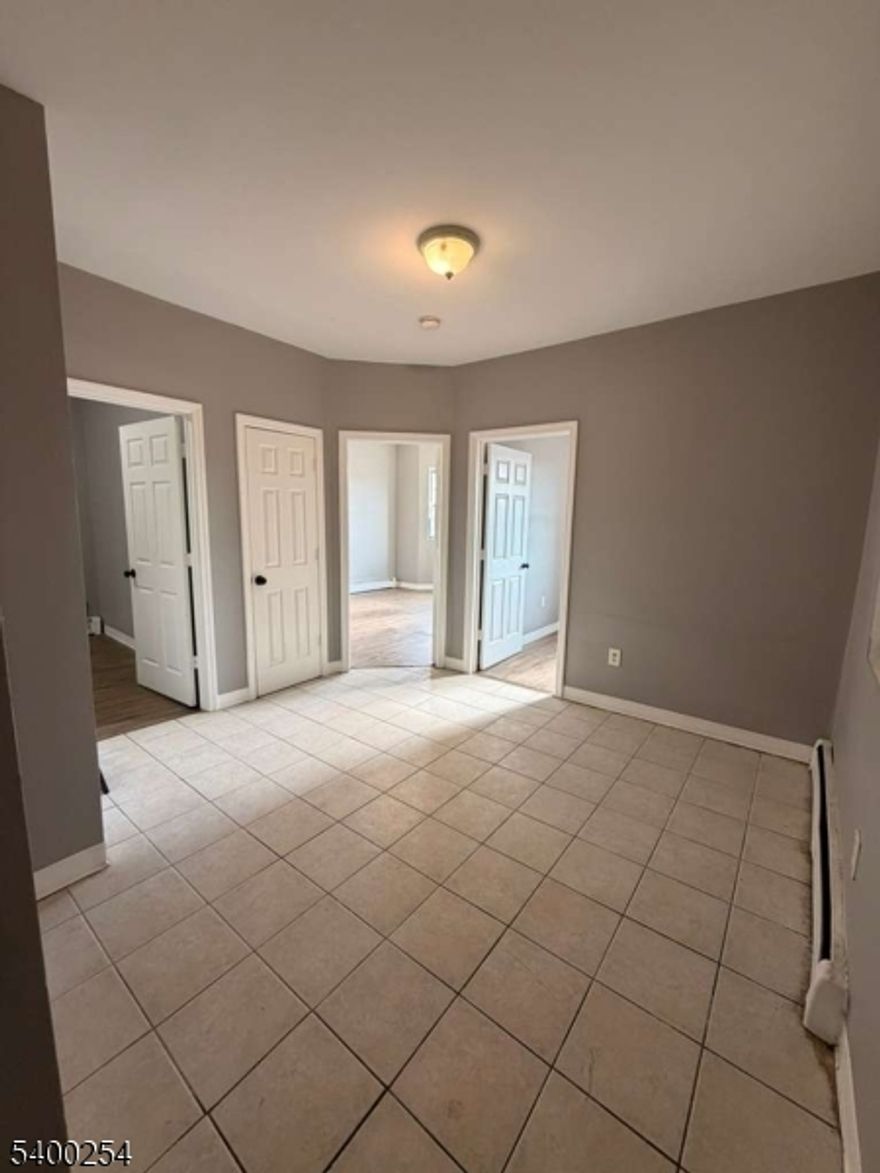 264 First St, Apt 6, located in the Elizabethport section of Elizabeth, offers a spacious 3-bedroom, 1-bath apartment featuring a bright living area, an eat-in kitchen with cabinet storage, and well-sized bedrooms with ample natural light. The bathroom includes tile finishes and standard fixtures. Conveniently situated near NJ Transit bus lines, the Elizabeth train station, schools, shopping centers, and the Elizabeth Waterfront, this location provides easy access to Newark, Jersey City, NYC, and major highways.