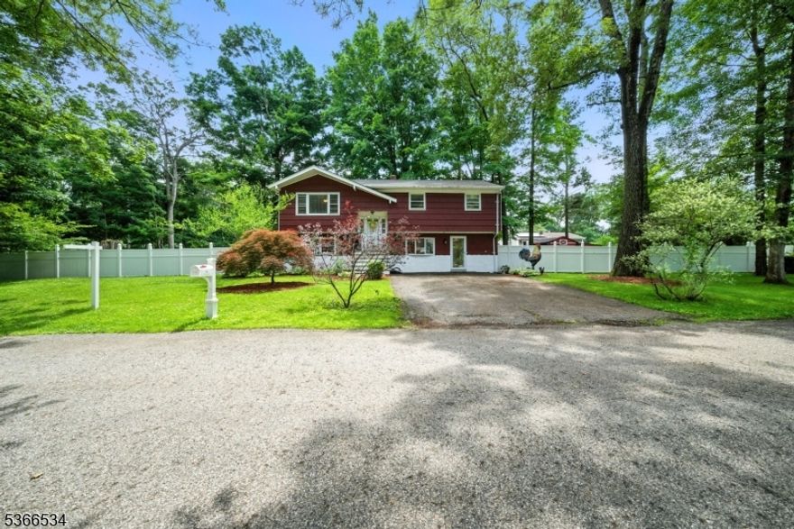 Welcome to Greenbrook Estates in West Milford! This 4-bedroom, 2-bath bi-level sits on a desirable corner lot and offers peace, privacy, and year-round access to Greenwood Lake without the lakefront price tag. Enjoy a new roof (2022), new boiler (2021), public water, and natural gas. The upper level features hardwood floors, a living room, dining area with deck access, kitchen (deep freezer included), three bedrooms, and a full bath. The lower level has a no-step entrance, a large family room, rec room, fourth bedroom (currently used as a gym), full bath, laundry room, and sliders to a fully fenced backyard with both a deck and patio perfect for entertaining.  Lake access is just a short walk away, and the seller has already paid for the first year of dock access. Community amenities include a pool and park. Conveniently located near NYC transit, shopping, dining, and outdoor recreation.  Don't miss this hidden gem! ** Per Sellers: H&B is due by Tuesday July 15th 5pm**