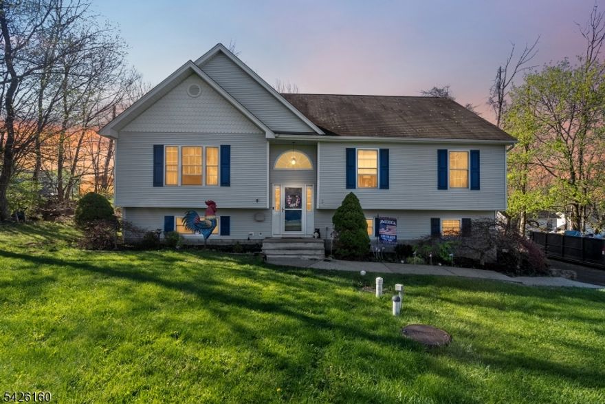 Welcome to this Bi-level home located in the desirable Upper Greenwood Lake section of West Milford. Offering 3 spacious bedrooms 2.5 bathrooms and a bonus room to with what you please, this home provides a comfortable layout ideal for everyday living and entertaining. Step inside to find recessed lighting throughout, complemented by a mix of tile flooring and natural light. The eat-in kitchen features lots of cabinetry, a center island, and ample space for casual dining, while a separate formal dining room adds flexibility for gatherings and special occasions. The inviting family room is highlighted by a cozy pellet stove, creating the perfect atmosphere during cooler months. All bedrooms are equipped with ceiling fans for added comfort. The finished basement offers additional living space, perfect for a recreation room, home office, or guest area. Outside, enjoy a spacious deck overlooking the forested property with fenced in areas.   Additional features include a 2-car oversized attached garage and a large driveway providing plenty of parking. Conveniently located with easy access to Upper Greenwood Lake, Warwick NY, Pennings Orchard and so much more. This home offers a great opportunity to enjoy both comfort and outdoor living.