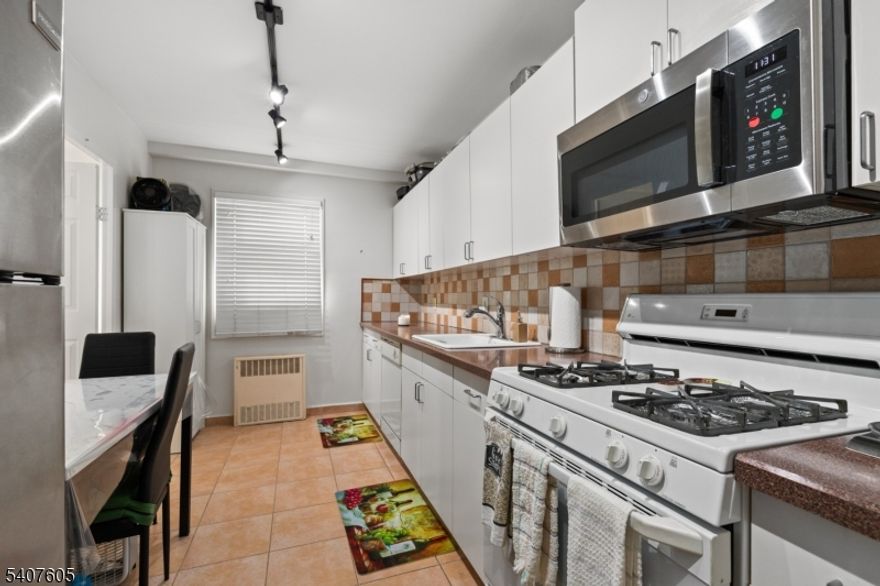 This oversized 1 bed co-op offers over 1,000 sq.ft of bright, well designed living space with sweeping NYC skyline views. Featuring tall ceilings, generously sized rooms, and a highly functional layout, this home delivers both comfort and flexibility. A welcoming entry foyer leads into an expansive living room and a formal dining area that can easily be converted into a den or home office. The eat in kitchen offers excellent storage and workspace, while the massive primary bedroom includes two large closets and easy access to the nicely updated bathroom. Thoughtful updates, ample storage, and an open flow make this unit ideal for both everyday living and entertaining. The Whitehall is a full service luxury building offering 24 hour doorman and security, a state of the art fitness center, outdoor pool with lounge area, BBQ space, community room with kitchen, on site management office, and a full time resident building manager. Reserved parking is available for a small additional fee. Perfectly located with an NYC Express bus right in front and train service just a few blocks away, this home offers unbeatable convenience for commuters. The monthly HOA fee includes taxes, insurance, gas, electric, water, storage bin, common area maintenance, and all building amenities. With continued redevelopment throughout Hackensack driving increased demand and long term value, this is an excellent opportunity to own in one of the area's most established and well regarded buildings.