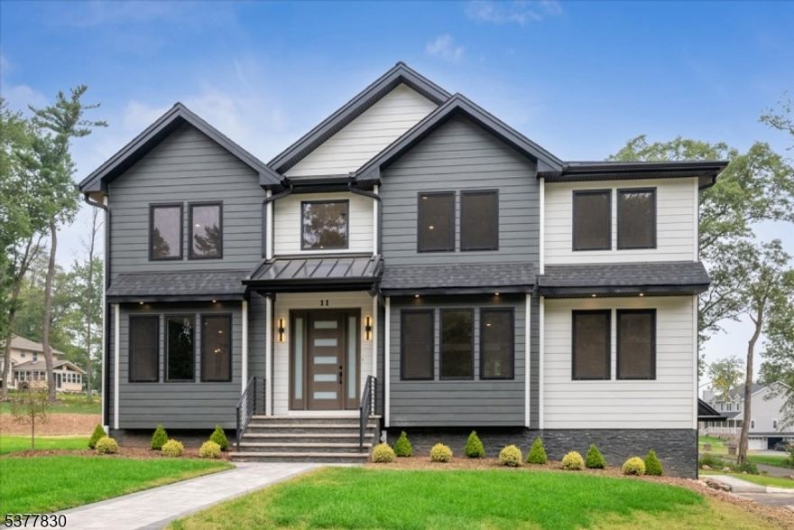 Stunning, bright, NEWLY CONSTRUCTED Colonial with a sleek blend of classic and contemporary finishes on tree-lined corner lot property in West Milford just minutes from dining, shopping, parks and more, with 5 bedrooms, 4.5 baths, an office, 3-car garage, and an inviting floor plan. A portico front entry leads you inside to a gracious interior highlighted by spacious, open floor plan, high ceilings, elegant details, crown molding and recessed lighting throughout. The 2-story foyer is flanked by a sunny living room and a dining room with adjacent butler's pantry with a wine fridge. Just beyond is an incredible, sun filled open kitchen and great room ready for relaxing and entertaining. This gorgeous chef's kitchen has ample white cabinetry, quartz counters, center island and high-end appliances, while the great room features a electric fireplace and wooded backyard vistas. A private office/den and discreet half bath off the living room complete this level. Upstairs, you'll find a generous primary suite with huge walk-in closet and luxurious bath boasting a dual vanity, soaking tub and oversized shower, as well as 4 more big bedrooms, two full hall baths, and convenient laundry. A finished lower level offers a sprawling rec-room/play room space with walk-out to the backyard, plus a bonus 4th full bath, utilities, storage and access to the attached 3-car garage. Everything's new and with warranty, nothing to do but unpack and enjoy!