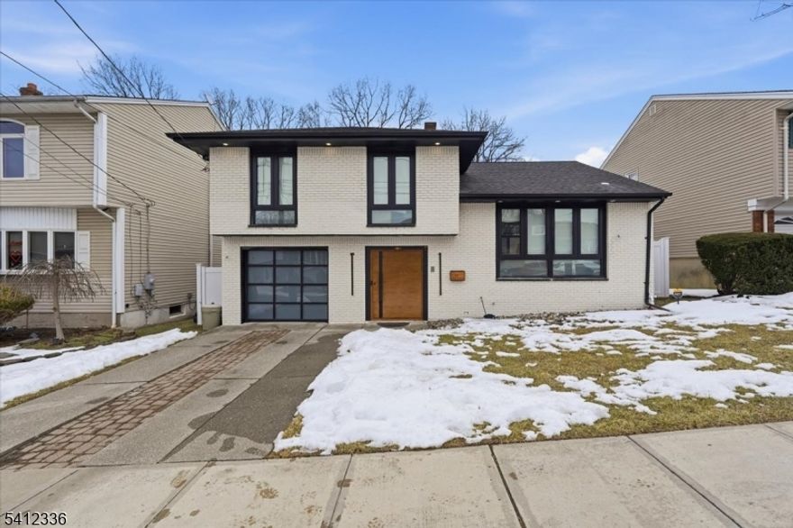 Floor-to-ceiling windows, a high-tech revolving front door, and a full-length deck overlooking Schmidts Wood set the tone for this beautifully renovated single-family home in Secaucus' desirable North End.offering 4 bedrooms and 4 full bathrooms, this move-in ready residence features an open-concept living and dining area perfect for everyday living and entertaining. The eat-in kitchen is equipped with granite countertops, a waterfall island, and brand-new appliances. Brand-new hardwood floors run throughout, complemented by freshly updated walls and ceilings for a modern, clean aesthetic.The spacious primary bedroom includes a private ensuite bathroom. A fully finished basement provides additional living space complete with a bedroom or a home office. Renovated throughout with quality finishes and thoughtful design, this home offers space, style, and versatility in a prime location right next to Schmidts Wood Park.