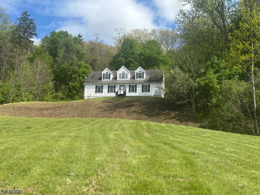Privately perched on a hilltop with Jenny Jump State Forest rising directly behind it, this custom cape home offers permanent, protected land that can never be built upon. Enjoy sweeping views & spectacular sunsets in complete privacy, just 7 minutes from Rte 80. This 2700 square foot home sits on 1.5 acres in desirable White Township - known for low taxes & excellent elementary school. Built by original owners, (2x6 construction) the home has been freshly updated with new neutral paint throughout. The 1st floor primary BR was recently updated with new flooring and a refreshed en-suite bath. Special features include vaulted ceilings, ceiling fans in each BR, a large loft used currently as a gym, and a huge loft level BR with its own bath. The very large finished walk-out basement includes a bar area, built-in bookshelves & French doors that open to a concrete patio with a custom fire pit. Additionally, you'll find an oversized 2 car garage with electronic openers, CAC, a 4-year old furnace, 1-yr old water heater & two 275 gallon above ground oil tanks neatly tucked away in the garage. Outside, you'll enjoy a brick patio with a permanent gazebo & dedicated BBQ area - perfect for relaxing and entertaining. Perfectly positioned between peaceful nature & everyday convenience, you'll find the rare combination of total privacy and modern comfort. All appliances are included. Don't miss your chance to own this special home - It's move in ready!