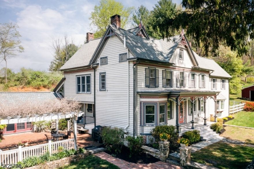 Welcome to Whipstick Farm, a heritage residence set on approximately five private acres off a private road with two other homes, offering usable land, seclusion, and a peaceful rural setting in Califon. Once a working farm, the larger property has been thoughtfully subdivided over time, preserving a sense of openness and connection to the land while allowing for comfortable private living. Believed to date back to the late 1700s, the main residence has been renovated and expanded over generations, blending historic character with practical living spaces. Original stonework and period details remain visible throughout, while updates support modern living. The kitchen features custom handcrafted cabinetry built from reclaimed materials and opens to a family room designed for everyday comfort and gathering. The primary bedroom includes an ensuite bath and enjoys separation from the additional bedrooms for added privacy. The property includes two historic out buildings, including a former dairy barn, plus a carriage house. The carriage house space previously used as a private office or studio offers electric service, natural light, and flexible use for work, hobbies, or creative pursuits. Rolling lawn, open fields, stone walls, mature trees, and a seasonal stream and pond complete the setting. A rare offering combining history, acreage, and flexibility in sought-after Hunterdon County. You'll fall in love with this one, come see for yourself.