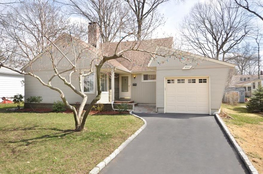 Charming Westfield residence on a quiet, tree-lined street offers strong curb presence with classic lines and mature landscaping. A large deck overlooks a peaceful backyard, perfect for outdoor enjoyment and entertaining. Attached garage adds convenience in this desirable location close to top Westfield schools, parks, and community amenities.Inside, discover generously sized rooms filled with natural light. The spacious eat-in kitchen features ample cabinetry and pantry storage, flowing into the adjacent living spaces. Four bedrooms provide versatile living options. Hardwood floors throughout add warmth, and the exposed brick fireplace anchors the living area with character. The lower level recreation room expands your relaxing and entertainment space. All this home needs is your own personal touches!