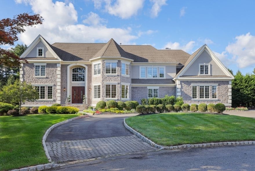 Exquisite Colonial home, with over 7,200 sq ft across all 3 levels, situated on a cul-de-sac in highly desirable Warren location. Featuring impressive mill-work, crown-moldings, crystal lighting fixtures,  coffered and tray ceilings, all visible throughout the home. The dramatic two-story foyer boasts travertine floors and a crystal Schonbek chandelier. Stunning two-story great room, filled with natural light, invites you to sit back and relax by the wood burning fireplace while you contemplate the great Warren scenery outside. The primary suite boasts over 1,100 sqft, including a private and expansive sitting room with fireplace, and a large master bathroom with heated floors. Five bedrooms total, five-and-one-half bathrooms, formal living and dining rooms, complete the main levels. The full and finished basement, equipped with a wet-bar, and a full bath, offers plenty of alternatives for entertainment, media room, recreation room, and exercise. The backyard completes this luxury home with spacious, yet private, outdoor stone patio with beautiful fireplace, oversized deck off the kitchen, 8-person hot tub, and plenty of mature and lush greenery. Warren is home to a great school system, and offers easy access to major highways, Short Hills and Bridgewater Malls and Newark-Liberty International Airport.