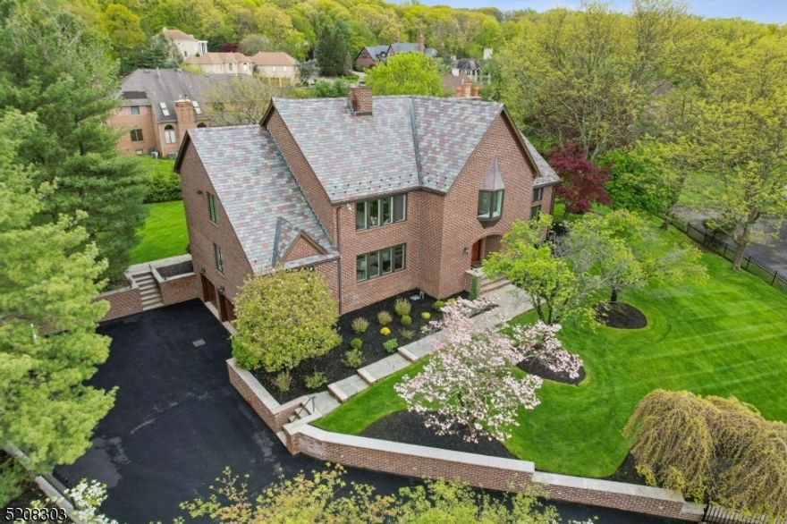 Exquisite, stately & elegant custom estate home nestled on large level gated property. Majestically situated w/the most stunning views! The wow factor is immediate from a block away. This solid brick home w/gorgeous real Slate roof & mature landscaping is a one of a kind & was just transformed w/a ground up restoration. Enter into a grand enormous entry foyer w/sweeping staircase--the elegance is immediate. The foyer opens to a opulent sun drenched formal LR w/soaring ceilings & floor to ceiling two sided stone fireplace--it is jaw dropping! LR opens to sunken den w/high ceilings & both open to warm & inviting FR. The FR is completely open to kitchen--offering modern open floor plan living. Two sets of sliders lead from FR to gigantic Blue Stone patio that peers over this amazing level property--this is an entertainers dream home! The gourmet Chef's kitchen w/prof. grade appliances, Quartz, custom tile & pantry--opening to formal DR w/astounding inlaid HW flooring, custom moldings & more. A main level quest suite w/full bath & separate entrance--perfect for guests or main level office. The upper level offers a primary suite that is unbelievable w/custom wood flooring, spa like bath w/soaking tub & immense shower stall. A custom built in office & customized WIC--this suite is like a resort. 3 addl bedrooms w/custom closets, large main bath & laundry complete this level. The LL offers media, wine room, exercise, Billiards, kitchenette, full bath, storage & more!