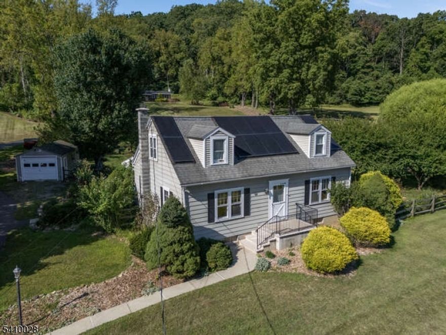 Beautifully maintained Cape Cod home nestled on a picturesque lot in a farming community. Upgrades throughout include stunning recently refinished hardwood floors. This home offers the perfect balance of comfort, character, and functionality. 3 BRs with 2 BRs conveniently located on the first floor. Two full Baths one on each level for added convenience. Spacious Living Room ideal for relaxing/entertaining. The Eat-In Kitchen features custom built-in bench seating with custom cushions. Large walk-in attic--tall ceiling--storage with access from the upstairs bathroom. Finished Basement with Recreation Room and Laundry Area with utility sink.  Ample storage in attic and basement. The large, covered wood deck offers a shaded retreat for outdoor gatherings. Beautifully landscaped, fenced rear yard with seasonal plantings featuring a welcoming stone patio. Convenient detached one-car garage off shared driveway. If you're drawn to sustainable features, inviting layout, or the idyllic setting, this home blends rural charm with modern conveniences. The Solar Panels are fully paid off. In the current market, electrical costs are continually increasing. SRECs are assigned to the new buyers with SRECs income. Solar panels offer a solution to increasing utility costs. Solar is a clean, energy source that is economical & sustainable. Schedule a showing today and experience the warmth and character of this beautiful home.