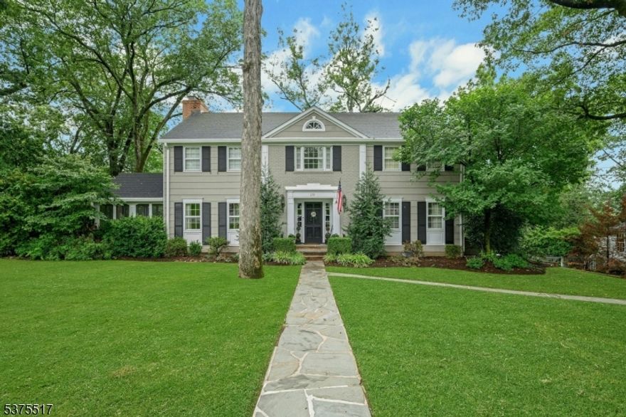 Welcome to this stately Colonial, set on a private, .4-acre lot on one of Summit's most desirable streets. This classic 4-bedroom, 3.1-bath home offers timeless appeal with well-maintained details and enduring charm throughout.  The first floor features an eat-in kitchen equipped with stainless steel appliances, granite countertops, and a Sub-Zero refrigerator. Formal living and dining rooms provide an ideal setting for entertaining, while the comfortable family room and an enclosed bluestone porch offer perfect spaces for everyday relaxation. A newly renovated powder room completes the main level.  Upstairs, the oversized primary suite includes a generous walk-in closet and en-suite bath. Three additional bedrooms share a hall bath with a double vanity and shower over tub. A separate office or library adds work-from-home convenience.  The walk-out lower level is a true highlight, featuring a large recreation room with a gas fireplace, a full bath with a stall shower, laundry area, and utility space. Direct access to the oversized two-car garage and a beautifully landscaped backyard enhances functionality and flow.  Lovingly cared for and move-in ready, this exceptional home offers comfort, character, and location all in one. A rare opportunity not to be missed.