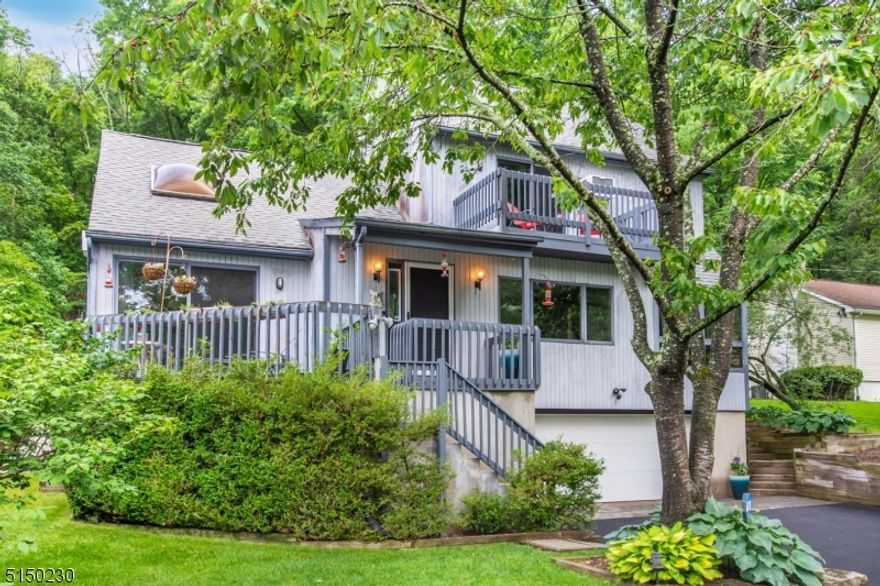 Beautifully landscaped and private yard is the setting for this very spacious contemporary style home!  2 bedrooms plus lots of flexible space and rooms, including loft area, sunroom, huge eat-in kitchen plus formal dining room, partially finished basement, sliders to balcony off primary bedroom suite, sun deck off living room, sliders to deck from breakfast area.  6 year old boiler, 3 year old water heater, storage shed, generator hookup and special touches, throughout.