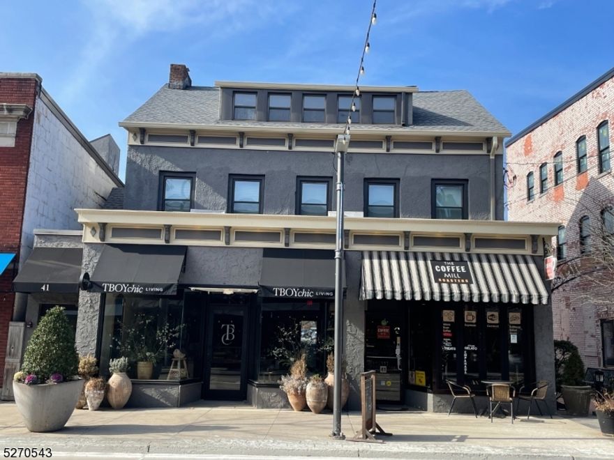 Prime downtown Millburn location - rare opportunity to own an updated and beautifully maintained investment property in the center of town. Just one block to train to NYC! Building is fully leased with four total units: two stores on the ground floor and two 2-bedroom apartments on the 2nd and 3rd floor.