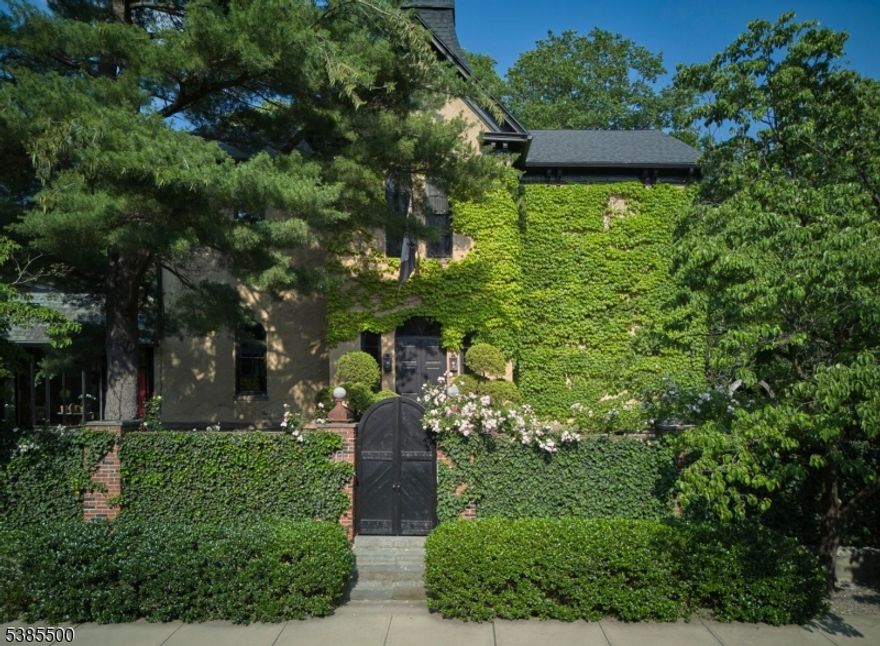 The Historic Italianate Schoolhouse is a one-of-a-kind residence where art, architecture, and modern living converge. Built in 1878 as Lambertville's First Ward School and reimagined over four years by New York art collectors, this 5,500 sq ft, 4-bedroom, 3.5-bath home blends preserved craftsmanship with state-of-the-art systems. The sweeping three-story staircase and cabinetry by Paul Evans remain, while updated mechanicals, Lutron lighting, and new windows ensure comfort and efficiency. Inside, 12-foot ceilings and oversized windows flood the home with light. The grand foyer leads to a living room with fireplace, wet bar, art gallery, and library/dining room. A wood-paneled sunroom opens to a private, illuminated walled garden by Buck Walter, with slate and granite hardscaping, multiple seating areas, secret garden, and parking for six plus an attached garage. The gourmet kitchen features top appliances, a large island, and custom commercial hood.The third floor offers a south-facing primary suite with sitting room, dressing area, and luxury bath with Fornasetti wallpaper and antique fixtures, plus two additional bedrooms. A fourth-floor private suite and an attic with climate-controlled gym add flexibility. Combining historic elegance with modern convenience, this rare property is both a home and a living work of art in the heart of Lambertville. Home is also available fully furnished.