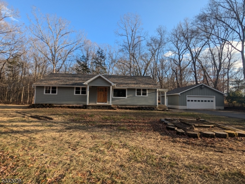 Welcome to your dream home! This beautifully renovated 3-bedroom, 2 full bathroom ranch is nestled on 1.6 acres of serene, flat land, offering the perfect combination of modern upgrades and peaceful living. This home offers all new features including roof, energy efficient windows, siding, furnace, central AC, hot water heater, hardwood floors throughout main level & new septic system. Home also includes an oversized detached 2-car garage, featuring brand-new roof, windows, insulated doors and automatic garage door opener.  This property is move-in ready and waiting for you to make it your own. Every detail has been thoughtfully designed to create a warm and inviting sanctuary. Property has a UST - Sold strictly As Is.