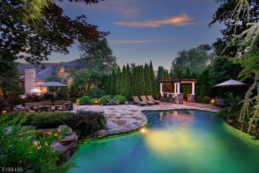 Luxurious daily living and grand entertaining in this one of a kind, pristine custom home set in one of the most desired neighborhoods-Castle Ridge Estates. Unique open design w/unrelenting quality throughout. Featuring nearly 8000 sq ft on 3 finished levels. Spectacular, private backyard oasis complete w/heated saltwater pool surrounded by Tennessee sandstone and featuring integrated sun bench, hot tub, grotto w/waterfall, & diving rock. Paver stone terrace w/grill, pergola and plenty of grass to play make this the perfect place to entertain or just relax. Indoor gatherings flow readily between the formal Dining Room, Family Room w/cathedral ceiling w/floor to ceiling stone fireplace. Living Room w/stunning custom bar. Designer Kitchen w/the finest appliances- (Subzero/Wolff/Fischer & Paykel/Bosch) hosts a center island w/breakfast bar, walk-in pantry, breakfast area with views of all seasons. 1st floor Bedroom w/adjacent full Bath, Office/Sunroom, Powder Room & Mudroom complete the 1st level. Two staircases ascend to the 2nd level. Double doors open to the Primary Suite featuring tray ceiling, enviably large custom closets, luxurious bath & sitting room/office.Three additional Bedrooms are accompanied w/Baths & custom closets. The lower level includes a media/entertainment area w/stage, half bath, guest/exercise room, multiple closets & large storage rooms. Hardcoat stucco. Countless upgrades! Easy access to shopping, all major highways, top rated schools, including Pingry.