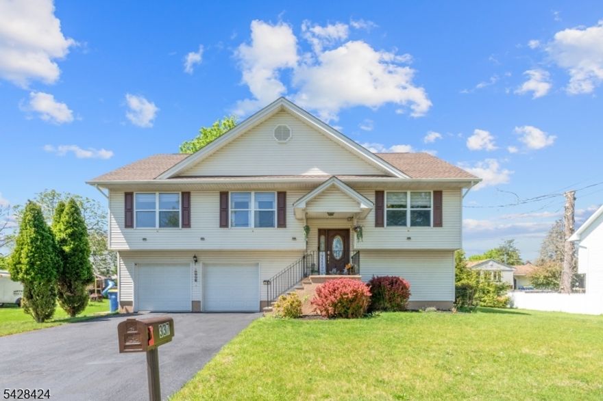 Welcome home to this spacious bi-level home, built in 1999 located in a quiet residential neighborhood. As you walk into the main level, you're immediately greeted by abundant natural light and soaring cathedral ceilings, creating an open feel throughout. The main level features an open layout with a large eat-in kitchen complete with quartz countertops and a center island, perfect for everyday living. A separate dining area and easy access through sliding doors to a deck ideal for outdoor dining. The oversized living room adds even more space to relax.This level also includes a primary suite with a full en-suite bathroom and walk-in closet, along with two generously sized bedrooms, a full bathroom, and a conveniently located laundry area. Ground level offers a versatile layout w/a spacious family/TV area and full bathroom perfect for guests or extended living. You'll also find access to the oversized two-car garage, as well as a walkout to the backyard, creating a shaded and private space for relaxation. Updates include a new roof (approx. 3 years old), water heater (2024), additional features include forced air heat, central air.Enjoy the convenience of a quiet neighborhood surrounded by nature, while still offering easy access to Routes 22, 287, and 78. Located near Rutgers University and Robert Wood Johnson Hospital, with Bridgewater and Somerville train stations nearby for commuting. Close to downtown Manville, offering local amenities and community programs.