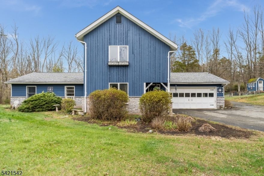 Welcome to this beautiful, 4 bed, 2.5 bath, custom home on an acre of land. The gorgeous, partially fenced in yard, boasts a fabulous lined pool, 2 sheds, and numerous colorful plantings, all surrounding the cozy patio that is lit up at night with accent lighting. The warmth and homey feeling of the hard wood floors, custom molding, 2 wood burning stoves (a wood burning in LR and a pellet stove in the den) vaulted ceilings, and the very generously sized rooms with great light, are hard to truly appreciate until you see them in person. The updated, spacious, eat in country kitchen with a walk in pantry, laundry room, and mud room adjoining, with sliding doors to the outdoor patio and entertaining area- is the center of the home and the flow makes it perfect for hosting all your family and friends.  2 bedrooms upstairs and 2 bedrooms downstairs with full baths on each floor. The larger bedroom downstairs was originally 2 rooms, so 2 large closets, is a very versatile space currently being used as an office/exercise room. This house offers an amazing amount of space in a quiet, beautiful, area. 2 attics, 2 sheds, and a garage for storage, in addition to numerous additional oversized closets and walk in closets off both bedrooms upstairs, make stockpiling your extra gems a piece off cake. This home is truly a must see!!