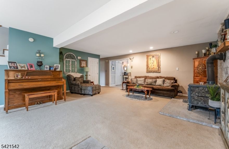 Welcome to this beautiful, 4 bed, 2.5 bath custom home on an acre of land with a gorgeous lined pool, partially fenced in yard, 2 sheds, and numerous colorful plantings, all surrounding the cozy patio. Hard wood floors, custom molding, 2 wood burning stoves (a wood burning in LR and a pellet stove in the den) vaulted ceilings, large sized rooms, great light. Spacious eat in country kitchen with a walk in pantry, laundry room, and mud room adjoining it. Great storage-numerous closets, and walk in closets off bedrooms. 2 bedrooms upstairs and 2 bedrooms downstairs with full baths on each floor. An amazing amount of space in a fabulous area. 2 attics for storage, the large bedroom downstairs was originally 2 rooms, it's a versatile space.  A must see!!