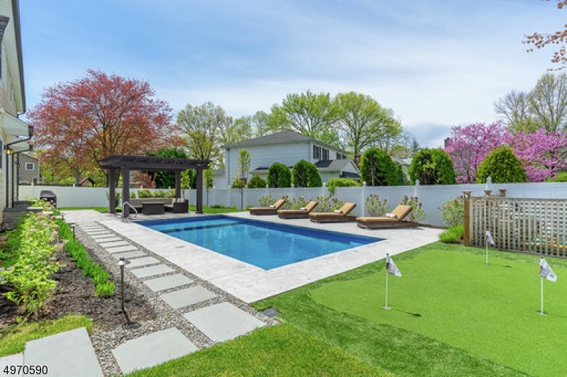 No expense spared in this 2017 built,5 bedroom,4 full bath home.Open concept floor plan, custom millwork,lighting,hardwood floors.Living room/office,formal dining room.Chefs kitchen w/custom cabinets,center island,coffee station,Jennair appliances, pantry and dining area w/sliders to back yard.Kitchen opens to family room w/gas fireplace&custom built-ins.Guest bedroom,full bath,and mudroom w/built-ins complete 1st floor.Master retreat w/enormous walk-in closet&spa like bath w/free standing tub&rain shower.3 spacious bedrooms,hall bath&laundry room complete this level.Third floor ready for 6th bedroom &bath.Lower level-media&game rooms,gym&full bath.Professionally landscaped exterior w/brand new salt water,heated pool&paver patio,sprinkler system,privacy fence,custom pergola and putting green. WOW!