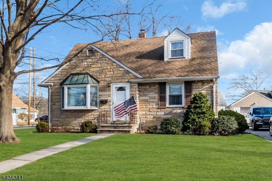 Expanded Cape Cod situated on a corner lot - Stone/Vinyl Siding Exterior- Central Air- Original Owner lived here- 3 BRS/2 Baths- Eat in Kitchen open to Formal Dining Room -Hardwood Floors under carpeting on main living area- Ample closet space throughout- The upper level offers an open area bedroom w/large closets, custom built in bookshelves and dresser drawers; potential for a 4th bedroom. Lower level family Room, laundry, utility rooom, and Workshop. 1 car detached garage. Paved driveway, established landscaping and garden area.  Desirable location with walking distance to town, schools, parks and close to major highways. A must see. AS IS Sale.