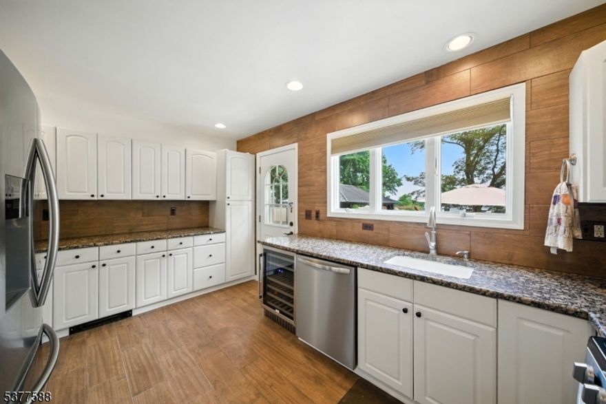 True Pride of ownership in this custom and charming home! Beautiful hardwood flooring. Lovely Architectural Features throughout, gives this Home a custom Lake Cottage Feel! Stunning kitchen with breakfast bar, pantry and stainless steel appliances. Open dining area with fireplace and a bright, large living room with multiple windows and tons of natural light. Convenient first floor powder room and mudroom. Office with french doors. Upstairs, a primary bedroom offers an en-suite bath. 2 additional bedrooms and an updated full bath with tub shower. Convenient laundry room. Full, partially finished basement accessed by spiral staircase. Neutral colors throughout. Super-sized garage. Beautifully landscaped back area with paver patio and pergola. Tremendous curb appeal! Enjoy all that Indian Lake has to offer. Fantastic location; walking distance to Indian Lake Bistro, ILCC Clubhouse, beaches, swimming, boating, playground & fun! Mins from DWTN Denville, NYC commuter locations for both bus & trains. Top Schools! House has been meticulously maintained.