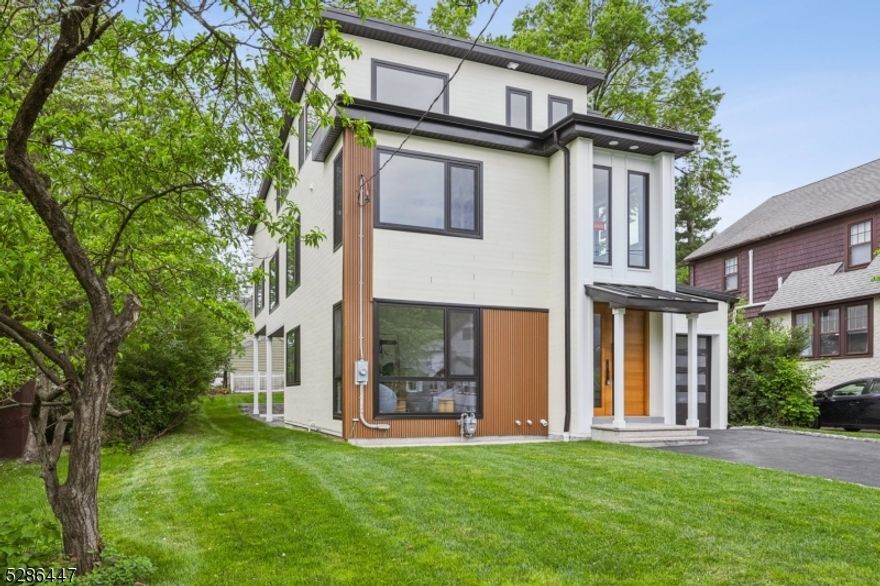 Stunningly renovated 6BR/5.5BA contempory house with 4100+ sq ft of living space set on .19 acre lot in the best location of the best town! This home boasts spacious open floor plan with 11ft high celing in family room areas with a gas place, custom-made contempory interior with modern hardware, custom closets throughout, all custom made heavy duty thermo-broken aluminum windows and patio doors throughout, double paneled tempered glass filled with argon, tilt and turn windows, 9ft and 10ft bi-fold doors connecting dining and family room areas. The kitchen is complete with high-end Thermador appliances, 36in gas cooktop, 36in  prograde range hood with 1000 CFM, 30 in combination wall oven and microwave set, 24in dishwasher, 10ft long waterfall center island with quartz counters on both sides ,quartz kitchen counters, and quartz backslash.The 2nd floor is home to a luxurious master suite, 3 additonal bedrooms, 2 full baths and laundry room. Both first floor and 2nd floor features 9ft ceilings.The 3rd floor features a large bedroom, a full bedroom, a 2nd family room. Fully finished basement with a rec room and powder room. Must See!!!