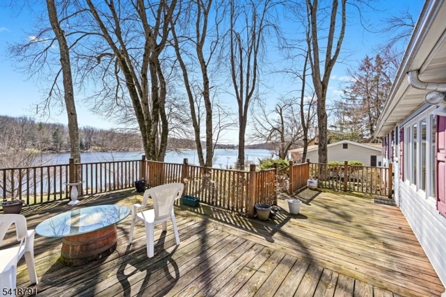 Sprawling lakesyle lakefront home boasting large windows overlooking stunning views, spacious rooms, 2 woodburning fireplaces. Rustic charm  Lakes offers 2 beaches, ballfield, playground, use of covered Pavillion and boating, canoeing, kayaking, fishing (no gas powered)
