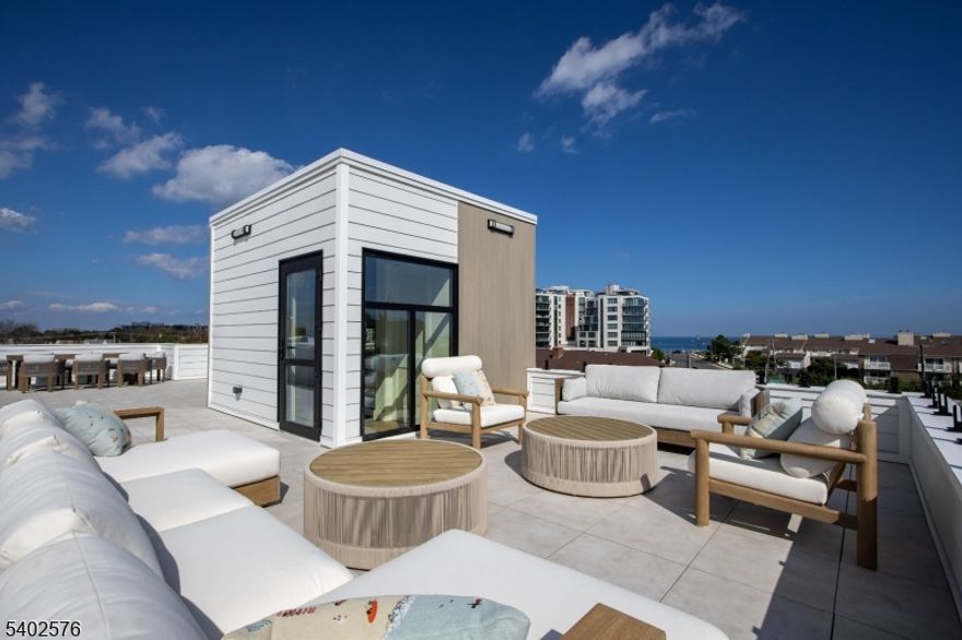 New Construction! Experience Unparalleled Luxury Living at The Seashore in Long Branch! Ride your private in-unit elevator up 4 levels to your expansive rooftop terrace & savor sweeping ocean views. Just minutes from the beach & Pier Village, this limited collection of 14 luxury townhomes offers close to 3,200 sqft of designer interior living space (+1108 sqft outdoors) with 3 bedrooms + den, 3.5 baths, multiple balconies & a heated, EV charger-ready garage. A modern masterpiece, each home features custom European windows and doors, open-concept living, and a chef's kitchen with premium smart appliances: Nostalgie by ILVE stove & SAVALO refrigerator and dishwasher. After a day at the beach, relax in the exclusive heated resort-style pool or explore the vibrant dining, shopping, and nightlife of Pier Village, Red Bank, Asbury Park, and Sea Bright, with NYC just a ferry ride away. Located minutes from the future home of Netflix, this is coastal luxury at its finest!