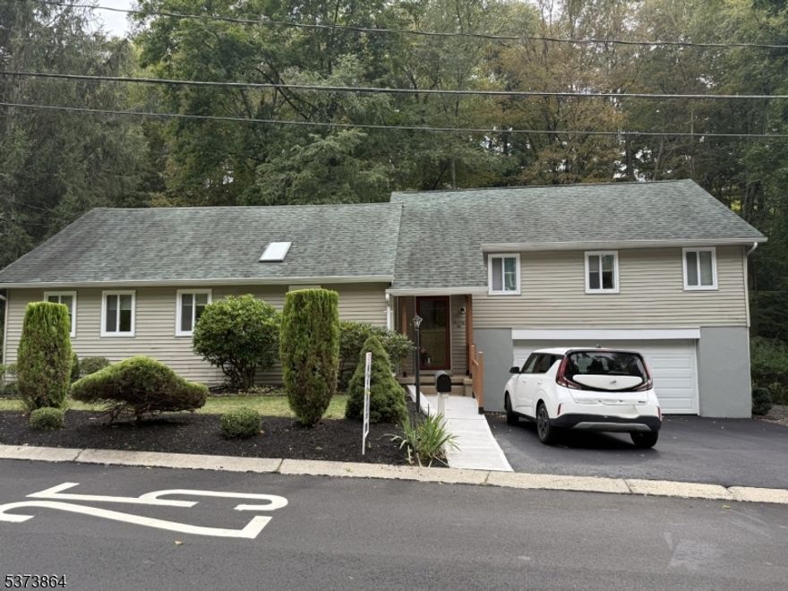 This unique home offers nearly 2500 square feet of living space featuring 4 bedrooms and 3 full baths. The foyer serves as the central hub of this home with the first floor consisting of the kitchen, living room and dining room with a door to the patio overlooking the backyard, as well as a first floor bedroom suite. To the right of the foyer the are stairs leading up to a den with fireplace, as well as 2 additional bedrooms and a full bath with double sinks. In the far left corner of the foyer are a set of stairs leading up to the spacious primary bedroom suite with sitting area and large walk-in-closet, as well as a full bath with double sinks. The 2-car garage also includes a fireplace. Freshly paved driveway and new sidewalk adding to curb appeal. Don't miss the opportunity to make this unique home your own! Schedule a viewing today!