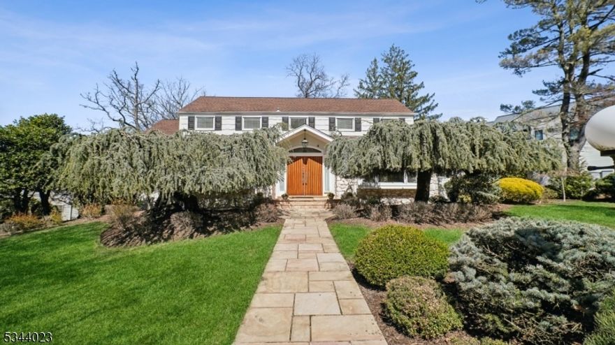 Be prepared to fall in love with this beautifully renovated, tastefully expanded & spacious 5 bedroom, 3 & 1/2 bath home with great amenities and a terrific, deep lot in an ideal Short Hills location! Luxurious 1st floor Primary Suite with bedroom with vaulted ceiling, a custom walk-in closet, new spa-like bath, and a private deck with stunning views. 2 more bedrooms share a beautiful updated bath to complete the 1st floor. 2 bedrooms share an updated bath on the 2nd floor. The gourmet kitchen features top of the line appliances, butler's pantry, and great natural light from large picturesque windows & sliding doors. There are 3 cozy wood-burning fireplaces, a great floor plan with the kitchen open to the family room & the dining room, and great natural light throughout the home. Finished walkout lower level features a rec room with a fireplace, wet bar, & sliding glass doors opening to the paver patio, + an exercise room & mudroom to attached 2-car garage. New expansive & lush yard with 3 patios & multiple hangout spots, perfect for entertaining. This home has it all! Terrific amenities include a standby Generac Generator, smart house features, 3-zone gas forced air heat, water softener/reverse osmosis water filter in the kitchen, new laundry, recessed lighting & all new light fixtures. Ideally located on a beautiful, deep lot with plenty of room for a pool on a quiet street close to highly rated Deerfield Elementary School & minutes to Short Hills Train Station. Low taxes!