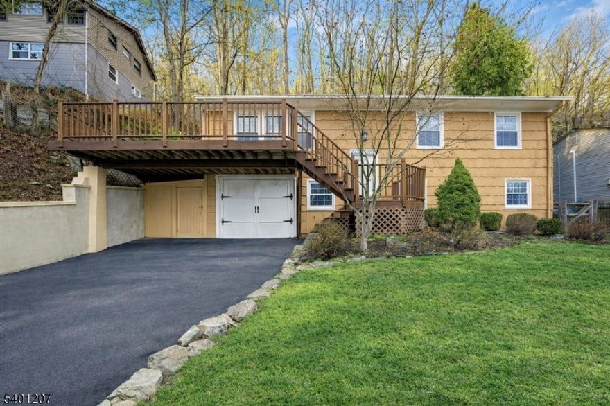 Discover a rare opportunity to own a bi-level home perched high on the Ramapo Mountains in Oakland's sought-after Crystal Lake community. Set on 1.36 acres carved directly into the hillside, this Southeast-facing retreat captures breathtaking sunrises, sweeping mountain vistas, and tranquil views of the Ramapo River and Crystal Lake below, yet remains safely elevated and high and dry above it all. Offering approximately 2,000 sq ft of inviting living space, the home blends natural beauty with everyday comfort. The spacious bedrooms with full sized closets and well kept bathrooms offer plenty of room to grow, rest, and recharge. A wrap around deck expands your living area outdoors, perfect for morning coffee as the mountains light up or quiet evenings surrounded by nature. The property's natural landscape is a blank canvas waiting for your vision whether you imagine a garden, a cozy fire pit area, or a peaceful private retreat amongst the trees. A workshop garage adds great functionality for hobbies, projects, or extra storage, and the upgraded lighting plus a three year young septic system provide convenience and peace of mind. All of this sits in a tranquil yet incredibly convenient neighborhood, just minutes from Routes 287, 208, and 17 for easy access to shopping, dining, and major commutes. This Crystal Lake hillside home offers unmatched scenery, privacy, and the perfect opportunity to add your own finishing touches an everyday oasis ready to make your own