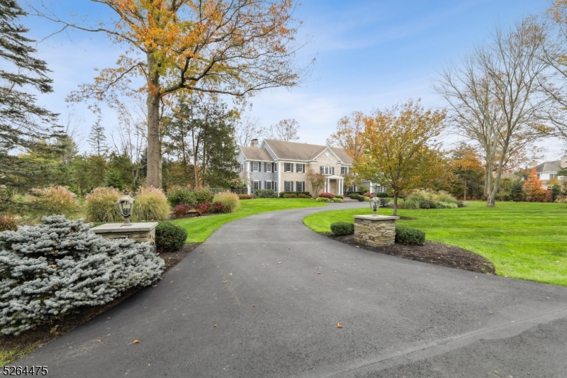 Magnificent Brick front Georgian Colonial Estate has all the hallmarks of Georgian Colonial architecture-- from its brick facade and portico entrance to the dormered rooflines and graceful symmetry.  Located in the historic Liberty Corner section of Bernards Township on a private cul de sac, this traditional residence has a Far Hills mailing address and is part of an intimate collection of just four luxury dwellings. The expansive 7250-plus square-foot layout offers five bedrooms, four full baths, two powder rooms, upstairs bonus room, expansive conservatory and an attached, oversized four-car garage. Surrounded by 3.47 lushly landscaped acres, the property is accessed by a paved circular drive. Highlights of the gracious floor plan include hardwood floors, ten-foot ceilings, a fireplace, generous room sizes, deep crown moldings, intricate millwork, tray ceilings, neutral paint colors and recessed lights.   A premier chef's kitchen presents custom painted wood cabinetry, granite countertops, an expansive center island with prep sink and seating. Upper-end stainless steel appliances from Bosch, Sub-Zero and Grohe are further amenities. There is also full, unfinished basement. Situated across the street from Dunham Park and is close to the quaint village of Liberty Corner, local schools and Interstates 287 and 78. Outstanding public and private schools. Easy access to New York City is offered by Midtown Direct trains in Bernardsville or via Interstate 78.