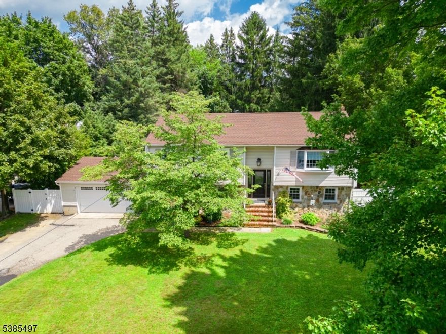 O P E N House Canceled! Welcome to this beautifully maintained 4-bedroom, 2-bath bi-level home, offering style, comfort, and plenty of space for everyday living. The upper level features hardwood flooring throughout, enhancing the warm and inviting feel. An updated kitchen boasts rich maple cabinets, sleek granite countertops, and flows seamlessly into the open dining area with recessed lighting. A sliding glass door leads to a spacious composite deck perfect for outdoor dining or relaxing. Three generously sized bedrooms are located on the upper level, each with large closets, while the fourth bedroom is privately situated on the lower level. The ground floor also showcases an oversized living space created by extending the garage, offering the perfect setting for a family room, entertainment lounge, or play area. Both bathrooms have been tastefully updated with modern tile flooring and finishes. Outside, enjoy your own private, fenced-in backyard oasis featuring an in-ground pool with a new liner installed in 2022. An attached 2-car garage completes this wonderful home. Garage fridge stays