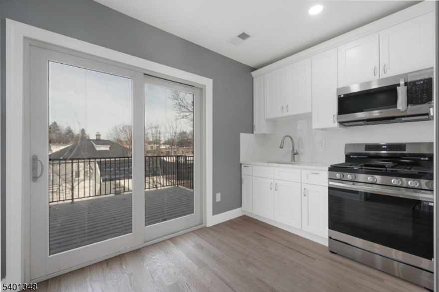 Beautifully renovated 2-bedroom, 1-bath apartment located on the second floor of a well-maintained 2-family home. This bright and spacious unit features a bonus finished attic room?perfect for a home office, guest space, or additional storage. Enjoy a brand-new kitchen with stainless steel appliances, wood floors, recessed lighting, and the convenience of in-unit laundry. A private patio/deck offers great outdoor space for relaxing or entertaining. Two driveway parking spaces included. Central air. Tenant pays utilities. Cats OK; no dogs.Prime location close to major highways, shopping, restaurants, and public transportation.