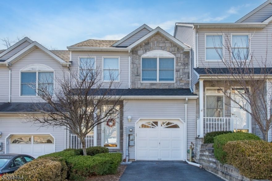 Move-in ready 2 bedroom 2 1/2 bath home in Glenmont Commons in Parsippany. You are welcomed into the 2 story foyer with oak hardwood floors and natural light. The open floor plan links the dining room, living room and kitchen. The living room has a wood burning fireplace as well as sliding doors to the deck with views to the wooded area beyond the complex. The kitchen offers granite counter tops and stainless steel appliances, including a refrigerator, 5-burner gas stove, microwave and dishwasher. A powder room and garage entry complete the main level. Upstairs are two spacious bedrooms both with walk in closets and en-suite bathrooms. The basement offers amble storage space and is a walkout that leads to the private backyard with hedges on both sides of the yard area. The home has a one car garage and its own driveway (not shared). The home provides easy access to shopping areas, restaurants and major highways. Home is located in Parsippany and is part of the Parsippany School District with a Morris Plains mailing address.