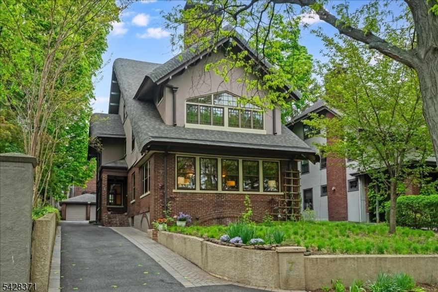 Some houses stop you at the door. This one pulls you in. Set on one of Montclair's original estate streets - just a short stroll to vibrant downtown restaurants, the movie theater, music venues, and the direct NYC train - this rare Craftsman blends timeless character with thoughtful modern updates throughout. Deceptively grand from the curb, this home unfolds in remarkable depth. Step inside and the materials do the talking - wood, stone, brick, copper, glass, fire - layered over a century and seamlessly updated. Beamed ceilings, rich wood paneling, three fireplaces - all effortlessly current. A cherry-paneled study. A renovated kitchen with soapstone counters and hand-crafted Motawi tile. The surprise is in the scale. Six bedrooms across four floors. The primary suite is dreamy in the truest sense - a generous bedroom, a sun-filled sitting room, and a brand-new spa bathroom you'll never want to leave: artisan handcrafted oversized soaking tub, stall rain shower, radiant heated floors, and Waterworks brass fixtures. Three more en-suite bedrooms. A fourth-floor loft currently a gym. Finished basement with home theater and wine storage. Two-car garage. Mini-splits throughout for effortless room-by-room comfort year round. Out front, a naturalistic meadow garden of fine sedges and spring bulbs just coming into its own - no irrigation, no mowing, just beauty. Steps from everything. Warm. Stylish. Welcome home.
