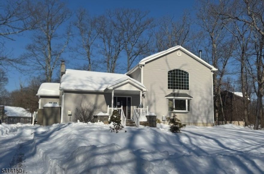 Welcome to this 3-bedroom Colonial-style home situated on a level corner lot. This spacious residence features an open two-story living room filled with natural light, creating a bright and airy atmosphere perfect for both everyday living and entertaining.The thoughtfully designed layout includes a dedicated home office, ideal for remote work or a quiet study space. Enjoy seamless indoor-outdoor living with a rear deck overlooking the yard, perfect for relaxing or hosting gatherings.