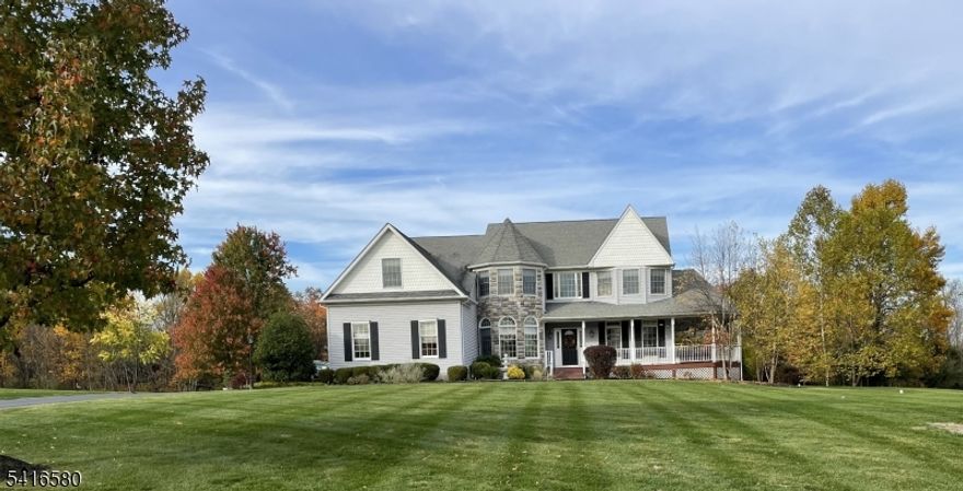 Welcome to this stunning stone-front home in prestigious Milestone Manor Development, offering exceptional space, elegance, &comfort. A beautiful paver walkway with stone pillars and Volt lighting welcomes you to the inviting wrap-around porch, creating the perfect place to relax with privacy & enjoy the outdoors.Inside, the home features impressive 9-foot ceilings, elegant moldings, recessed lighting, & French doors throughout. The dramatic two-story family room is the heart of the home, showcasing wood flooring, updated moldings, a gas fireplace, & a mounted big-screen TV area perfect for entertaining or relaxing evenings. The spacious kitchen is designed for both everyday living & entertaining, featuring granite countertops, stainless steel appliances, tile flooring, a center island & a bright dining area that opens to an expansive deck. The formal dining room offers a charming bay window & direct access to the wrap-around porch, while the formal living room features beautiful wood flooring.The first floor also includes an office, powder room, & laundry room. Upstairs, the spacious ensuite includes a huge walk-in closet, granite countertops in the bathroom, while three additional generously sized bedrooms complete the 2nd level.Additional highlights include a whole house generator, 3-car carpeted garage, walkout basement offering endless possibilities & beautiful designed exterior details.Ideally located to Flemington's shopping, restaurants, & major highways.