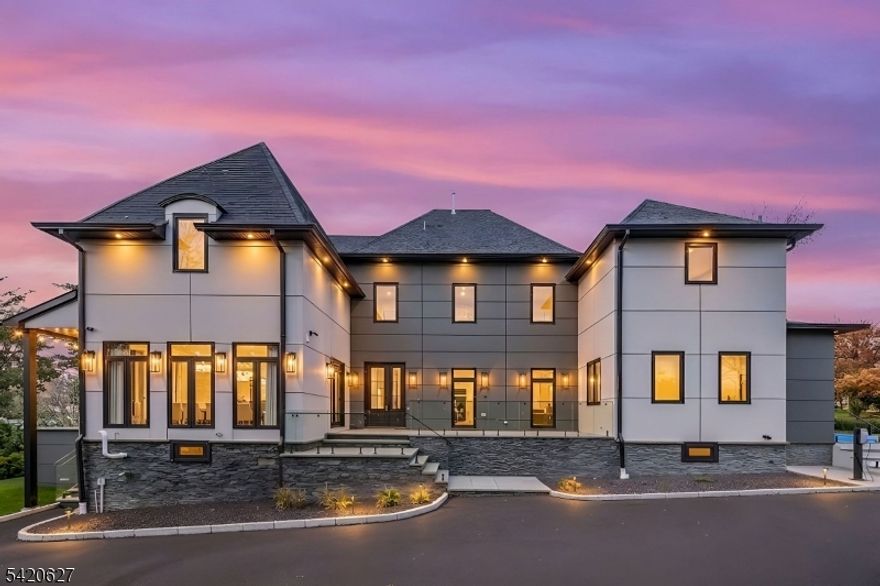 Experience luxury living in this brand-new Modern French Chateau with over 8,500 sq ft of meticulously crafted space across four levels featuring soaring ceilings and exquisite attention to detail. Designed for entertaining, the chef-inspired kitchen boasts commercial-grade appliances, a dramatic 15-foot marble waterfall island, and matching backsplash. The second level offers four spacious bedrooms with spa-like marble baths, custom vanities, and heated floors, while the primary suite provides a private retreat with soaking tub, walk-in shower, dual vanities, and two walk-in closets. A finished attic with vaulted ceilings, automatic skylights, full bath, and lounge area adds versatile space. The fully finished walk-out basement includes an entertainment room, bedroom, gym, full bath, and multiple recreation areas. Outdoors, enjoy professionally landscaped grounds with two bluestone patios an expansive rear patio for grilling and fire pits and a side patio for lounging plus a private rear lawn. Additional features include four-zone central air, whole-house generator, integrated speakers, heated bathroom floors, whole-home water filtration and softener, two tankless water heaters, and detailed custom millwork. Ideally located in Upper Saint Cloud with easy access to top schools, shopping, dining, highways, and NYC transportation.