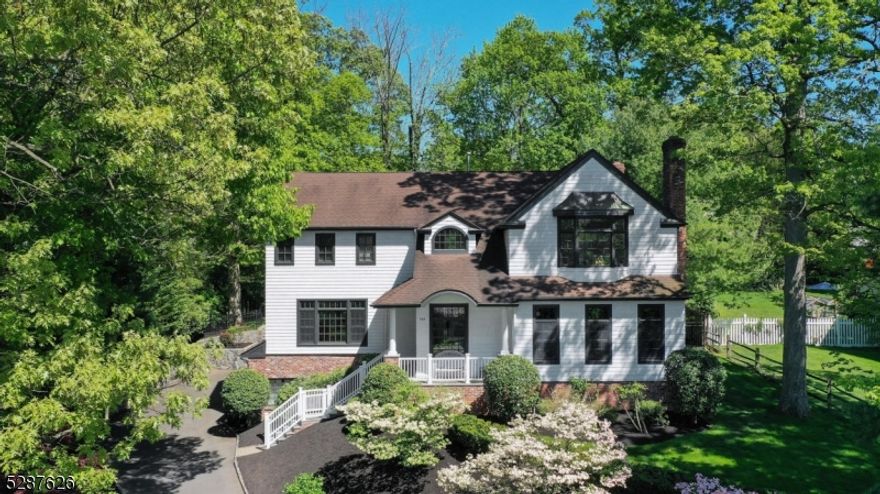 Become the second proud owner of this splendid colonial, just a stone's throw away from downtown Summit. Boasting 6 bedrooms, 4 full baths, and one half bath, this magnificent 6000+ sq ft home sits majestically on a 1/2 acre lot, offering a private, level backyard sanctuary. Step inside to be greeted by the grandeur of a two-story foyer with a soaring vaulted ceiling. The Living Room welcomes with its 10 ft ceiling, abundant windows, and a cozy woodburning fireplace. Adorned with a bay window and custom built-ins, the Library opens to a wet bar and Powder Room. Relax in the spacious Family Room featuring another woodburning fireplace and French doors leading to the patio. The Kitchen, accessed through an arched entry, delights with its center island, custom cabinets, high-end appliances, and adjacent Breakfast Room. Enjoy sunset views from the Dining Room, framed by a wall of windows flooding the space with natural light. Upstairs, retreat to the expansive primary suite offering serene backyard vistas, a full bath, and ample closets. A dedicated Office with westward views caters to your WFH needs. A hall bath and a jack-and-jill bath service 4 additional bedrooms. The basement boasts an enormous Recreation Room, Bedroom, Full Bath, and access to a 3-car Garage with dumbwaiter. This home showcases 9' ceilings on basement and 1st levels, custom millwork, and a full house generator, fulfilling every desire for luxury living. Don't miss out on this exceptional opportunity!