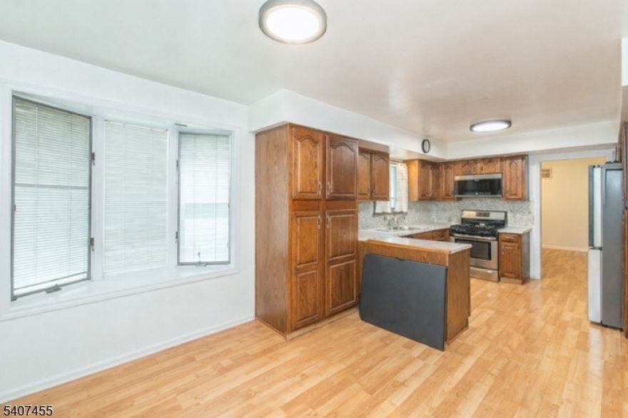 Exceptional Two-Family Home with Updated Systems & Bonus 2,800 Sq Ft Commercial Warehouse. Discover an outstanding investment or owner-occupied opportunity with this well-maintained two-family property, paired with a fully gutted 2,800 sq ft business-zoned warehouse (new roof 2025) perfect for entrepreneurs, storage, or additional rental income. This unique property offers versatility, strong rental potential, and valuable commercial space all in one package. Ideal for investors, mixed-use buyers, or those seeking live-work flexibility. Second-floor unit offers a massive master bedroom and full bath. First-floor unit includes two bedrooms, one bath, a massive family room with stone fireplace, new vinyl plank floors, and bamboo flooring. Living room is potential 3rd bedroom. The Walk Out Basement is fully plumbed for a full bathroom and features newer water heater and boilers, new steps, and new interior/exterior basement doors. Warehouse is fully gutted and ready for your vision. Conveniently located with easy access to NYC transit, bus terminals, train services, and airports. Offered in its present condition, providing a canvas for your vision with endless business potential!