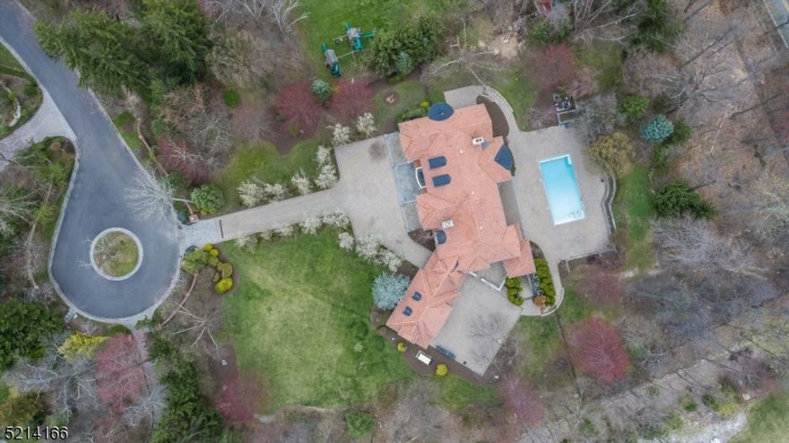 Gracefully poised on a cul-de-sac at the end of a gated driveway, this remarkable residence featuring 7 bedrooms and 7.3 baths offers luxury living in a private setting. Manicured grounds with mature trees enhance the stately exterior and welcome guests into this captivating home. A soaring 2 story entry foyer with sweeping staircase leads to a grand great room with floor to ceiling windows capturing the natural light and private back yard views. Thoughtfully designed formal living room and game room. Gorgeous dark wood inlay office. The gourmet kitchen features a large center island, and ample counter space, making it the perfect space for enjoying meals. The adjacent breakfast area offers stunning views of the lush backyard and provides a warm and inviting ambiance. Come and appreciate the architectural details, exquisite woodwork, & impeccable craftsmanship in this home.Grand primary en-suite with light filled, circular sitting room, fireplace, WIC, 2 additional closets. High ceilings throughout the house, expansive walk-out lower level with secondary kitchen, bathroom, stage, fireplace and cedar closet room, storage room and multiple closets.Enjoy the summer in the fabulous in-ground pool with hot tub or lounge on the expansive paver patio.