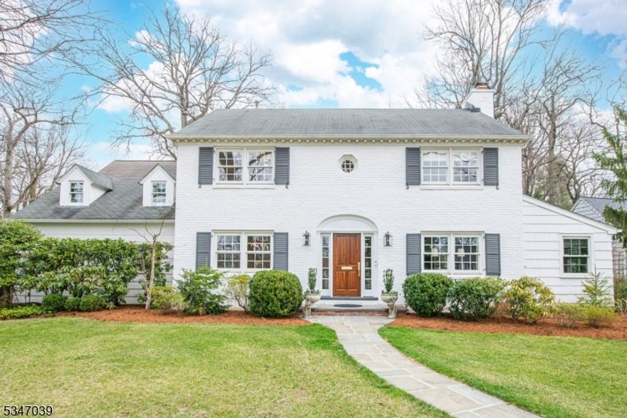 Welcome to this beautifully updated 5 BR, 3.5 BA Colonial in one of Summit's most desirable neighborhoods - just minutes from top schools, downtown, and Midtown Direct trains. Featuring a 2 car attached garage and situated on 0.61ac lot, the home blends timeless charm with modern updates. Inside, you're welcomed by elegant millwork and hardwood floors throughout. Graceful arched openings create seamless flow between the formal dining room, living room with wood-burning fireplace, versatile sunroom, and sun-drenched family room with built-ins and pocket doors.The stunning eat-in kitchen is a chef's dream, with a large island, breakfast nook, Subzero fridge, Dacor range and oven, dual sinks, quartz countertops, and custom cabinetry. A wet bar connects to the formal dining room, while the adjacent mudroom and powder room offer thoughtful touches. Upstairs, the primary suite includes a walk-in closet and renovated bath. Three additional bedrooms share an updated full bath, while a separate guest/au pair suite has its own full bath and private staircase.The finished lower level offers a rec room, gym/play area, laundry, and storage. Outside, enjoy a brick patio, mature landscaping, and a storage shed.