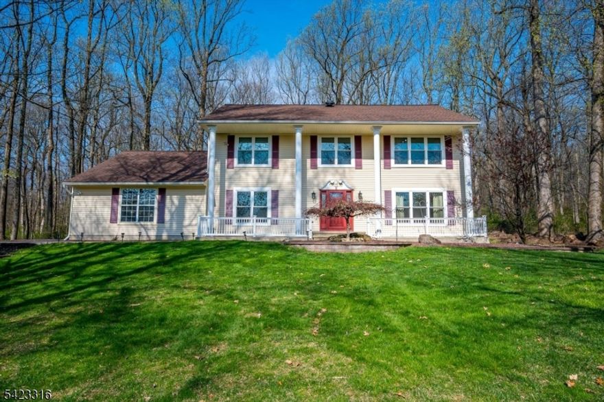 Set back on a gentle hill and backing to wooded open space, this east-facing center hall colonial offers great living space, privacy, and a strong overall setting. Situated on 2.3 acres, the home delivers natural light and a layout that lives well day-to-day.The main level features a two-story entry, oversized family room with fireplace, and formal living and dining rooms with gleaming hardwood floors true, usable common space throughout. The eat-in kitchen is designed for everyday living, with granite countertops, a center island, and an expanded breakfast area that opens naturally into the family room.Upstairs, the primary suite includes a modern bathroom with soaking tub, separate shower, and peaceful views over the property. Three additional bedrooms are all well-sized and filled with natural light.A full finished basement adds flexible living space and has been fully waterproofed with a perimeter drain system, vapor barriers, and a sump pump already in place. The 3-car garage, blacktop driveway, and Trex deck round out the exterior. Major components have been maintained, including well pump, septic system, central air, and kitchen exhaust. The home is also equipped with a Generac backup generator, providing full-home power security and peace of mind.