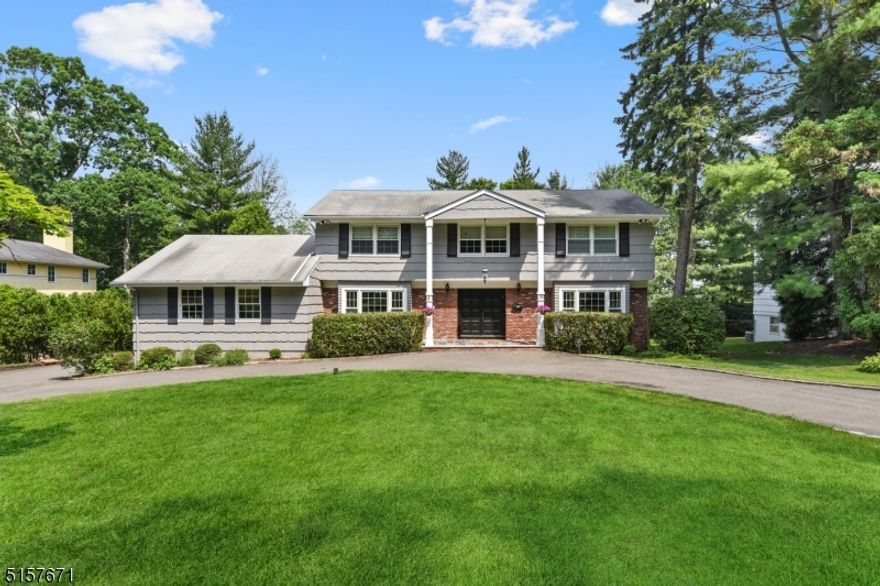 Modern luxury and exquisite design are uniquely embodied in this truly spectacular Short Hills show stopper! Sensationally updated 5+ Bedroom, 4 Full and 1 Half Bath custom colonial situated on a gorgeous level property with westerly views and stunning sunsets. Located in the Mountain Top area of the highly coveted Deerfield Elementary section, this expansive home is loaded with designer finishes everywhere and multiple outdoor entertaining spaces. Elegant Foyer with 2 double coat closets and an open staircase leads to Formal Living Room and Dining Room. True entertainer's Kitchen features granite counters, glass tiles backsplash, high-end stainless steel appliances, and direct access to the fabulous Deck which runs length of home. Convenient 1st floor Laundry Room, attached 2-car garage, Powder Room + Bedroom and Full Bath. Enormous Great Room with statement fireplace opens to Kitchen and Deck. 2nd level features a large double-height open staircase with a large landing and boasts 4 bedrooms. Primary Suite retreat features hardwood floors, substantial walk-in fitted closet + 2 additional closets; and a luxurious Primary Bath. 3 more bedrooms are all well appointed with double fitted closets, plenty of sunlight and hardwood floors. Full Hall Bath with a double sink vanity and wainscotting completes the second level. Lower Level Recreation Room with a full wet bar, 2 bonus rooms with closets and Full Bath + fully equipped Summer Kitchen directly accessible to covered patio.