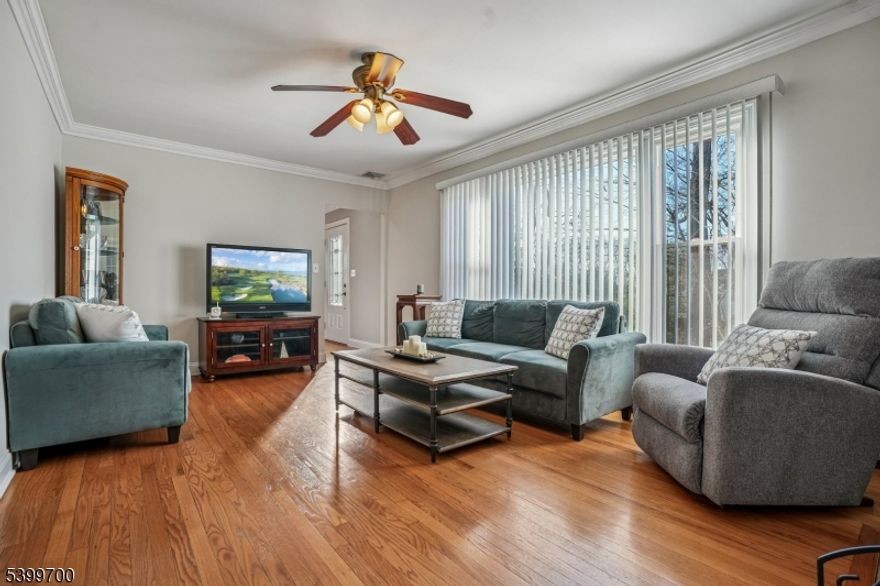 Lyons Train Station 1.1 mi, Starbucks 0.8 mi, Pleasant Valley Park 0.9 mi, Stop and Shop 1.0 mi, Lyons Mall 0.7 mi, Ridge High School 2.4 mi. Central Basking Ridge location with easy access to Routes 287 and 78 and about 40 minutes to Newark Airport. This Cape-style home offers a warm, flexible layout with thoughtful updates and convenient access to everyday needs. The living room features hardwood floors and a white brick wood-burning fireplace with a custom mantle, opening to an office or first-floor bedroom with French doors and easy access to the full bath and kitchen. The cherry kitchen includes granite counters, newer stainless appliances, a space-saving recessed refrigerator, a corner pantry closet, and a door to the backyard. Upstairs are two spacious bedrooms with ceiling fans, floored eave storage, and a renovated full bath with a stall shower. The finished basement adds a large family room, extra storage, laundry, and outside access. Hot water baseboard heat, central air, newer windows and gas heat add comfort and convenience. A covered porch connects to the one-car attached garage, and the paved driveway offers room to turn around, eliminating the need to back out onto Mt Airy Rd. Close to NYC trains and major highways, this home blends privacy with easy everyday access.