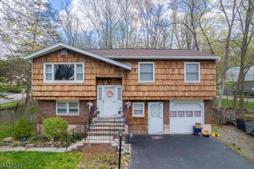 Bi-level single-family home offering 4 bedrooms and 2 full baths with approximately 1,827 sq ft of living space in West Milford. Features an oversized primary bedroom and three additional bedrooms, along with bright living areas on both levels. Situated on a .27-acre lot.