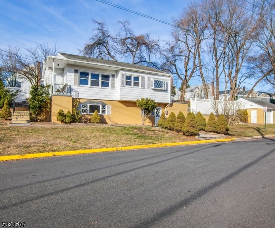 A paver walkway greets you and leads to a lovely open front porch, welcoming you into this beautifully renovated raised ranch for rent on a desirable corner property. The main level is bright and filled with natural light from large windows. The charming eat-in kitchen features chair molding, high-end stainless-steel appliances, wood cabinets, quartz countertops, porcelain backsplash, an adorable picture window, and direct access to the deck. The dining area, with an elegant chandelier, flows seamlessly into the spacious, light-filled living room with a ceiling fan for added comfort. Three bedrooms offer generous closets, a full hall bathroom, and refinished hardwood floors throughout. The lower level includes a huge family room with a gas fireplace accented by a ceramic tile and beautiful flooring, plus an office/media room with outside access, a large full bath with decorative tile and quartz vanity, and a laundry area with newer washer and double-capacity dryer. Additional highlights include central air, recessed lighting, abundant closets and storage and freshly painted throughout in neutral tones. Enjoy outdoor living with a huge paver patio and built-in fire pit, perfect for dining and entertaining. The property also includes a one-car detached garage. Situated in a great neighborhood, only a stone's throw from the NY bus stop, with easy access to shops, restaurants, and more.