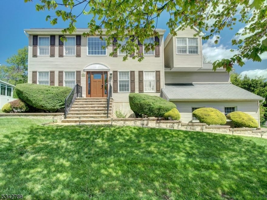 Beautiful 5 bdrm, 2.5 bath Colonial, located in desirable Hunters Ridge community awaits you. Lovingly well cared for home will win your heart upon entering Impressive 2 story foyer--Iight, bright & inviting. It also features a finished bsmt w gym that is also accessible through garage. This home is a true delight in today's market. First floor boasts newer laminate wood floors, updated kitchen w center island, subway tiled backsplash, stainless steel appliances, garbage disposal & granite countertops. Separate dining area has french doors that lead to expansive sized deck (26'x21') perfect for entertaining or just relaxing to enjoy the tree lined yard. Huge bonus is the custom built outdoor bar & water line supplies for gardening. Family rm is adjacent to kitchen & has a beautiful fireplace w tile surround & custom mantle. Living & dining rooms, powder rm, laundry rm & 5th bdrm complete 1st flr. Second floor has 4 bdrms including primary suite w newer updated bath featuring brand new master shower, tile, hardware, lighting, granite counters on dual vanity w beautiful vessel sinks. Three other spacious bdrms & main bath complete 2nd level. The well maintained, fenced yard is spacious & has built in brick fire pit for smores night. Gas grill is included & for convenience there is a gas line directly from the house. Other highlights: brand new shutters, solar panels for great savings, new garage doors w cameras, new leaf filter gutters & more. Public Utilities here!