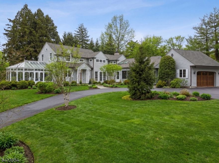 Custom expanded ranch renovated in 2020 with fabulous architectural detail and millwork throughout. Light drenched interiors with walls of windows, hardwood floors, and multiple skylights. Living room with gas fireplace, French doors leading to temperature controlled Solarium and open to gourmet kitchen with marble countertops, center island, SubZero refrigerator, Bosch dishwasher, Wolf cooktop and wall oven and built in microwave. Breakfast area with built in banquette open to bluestone patio. Family room with stone surround gas fireplace and built in bookshelves. First floor primary bedroom with vaulted ceiling, window seat, custom walk in closet and en-suite bathroom. Second floor with 3 bedrooms, office, and 2 full bathrooms. Situated on .86 acres with circular drive and private backyard with Koi pond. Previous two car garage has been converted to studio with vaulted ceilings and skylights. Perfect for a home gym, additional office space, or recreation area. Close proximity to town and train station!