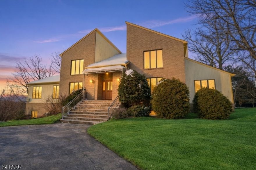 Welcome to 32 Sylvan Drive, an exceptional residence in prestigious Windsor Woods neighborhood. This south-facing property, perched atop a hill, offers unparalleled views and a prime location. This 4,436 sqft home is both comfortable and spacious, featuring five bedrooms and four and a half bathrooms. The open floor plan and large sized rooms provide an ideal setting for modern living. The main level boasts a large eat-in kitchen with sliding doors leading to a deck. A spacious 36-foot living room with a wood-burning fireplace, formal dining room, office space, and additional entertainment areas complete the main floor.This property offers flexible living options with two primary bedrooms, one on the main level and the other on the second floor, each with ensuite baths. The finished walk-out lower level, has separate entrance and bathroom, adding more living versatility. Hardwood floors and marble tiles grace the main and second floors. Main-level laundry further adds to the home's practicality.1 block to Woodmont Elementary School, rated 9/10, easy access to major highways; Routes 46, 80, and 287, and NYC transportation. The property set on a .75 acre lot features a circular driveway and three-car garage, with plenty of storage. The south-facing orientation ensures abundant natural light and breathtaking sunset views. Montville Township is renowned for its prime location, offering a harmonious blend of suburban tranquility and urban accessibility.